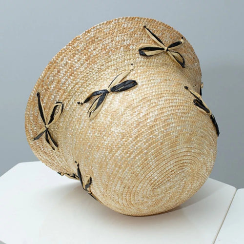 Straw bucket hat with black bowknot decorations, woven straw dome