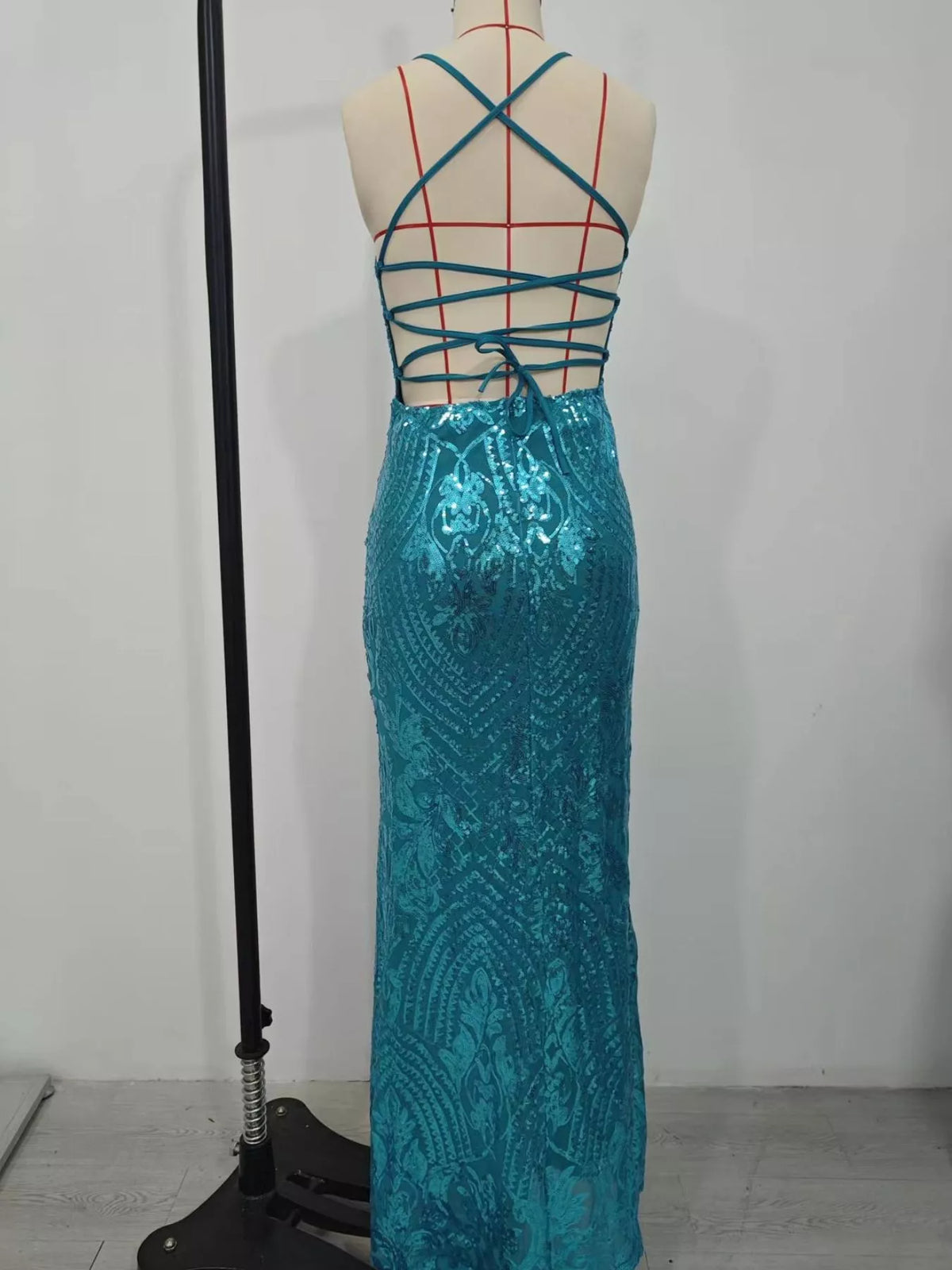 Turquoise sequin backless evening dress rear view on mannequin with crisscross straps