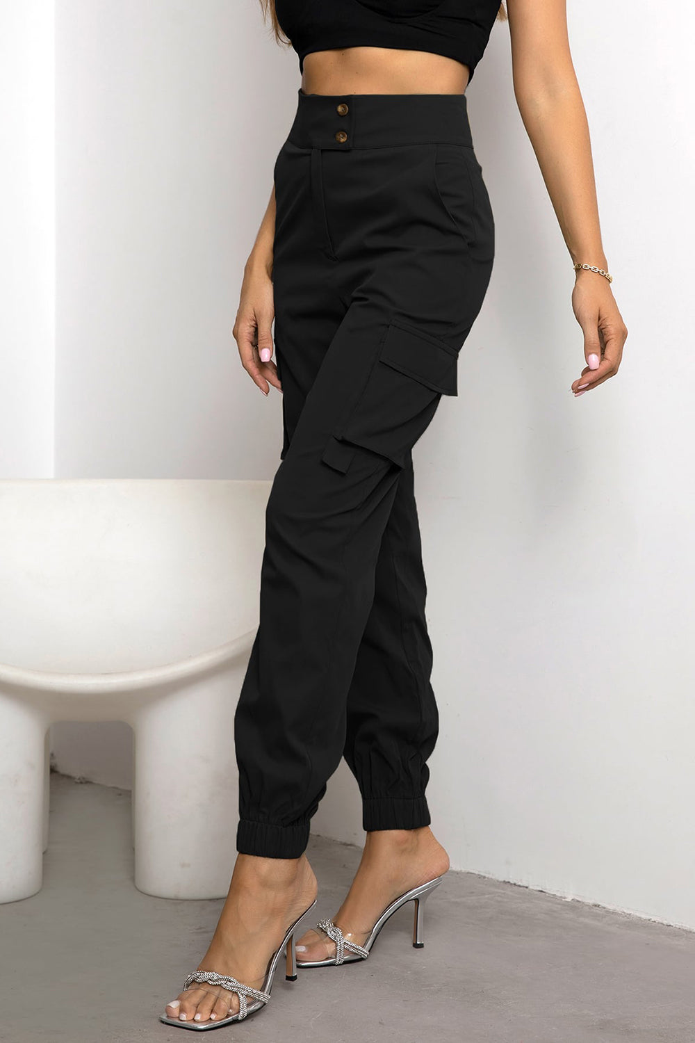 High-waist cargo pants, black with draped side cargo pocket and cuffed ankle jogger hem