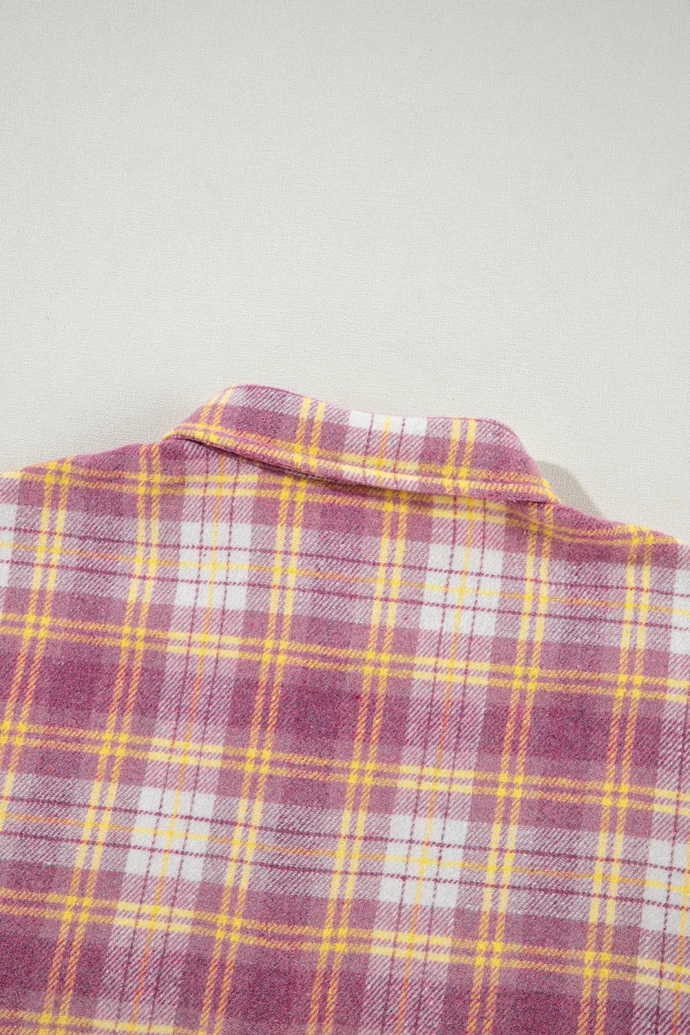 Pink plaid shacket collar close-up with button placket detail