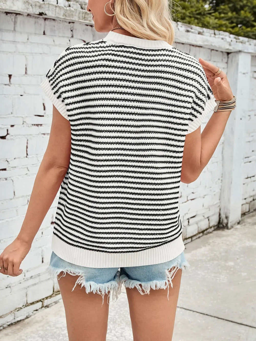 Back view of black and white striped round-neck cap-sleeve sweater