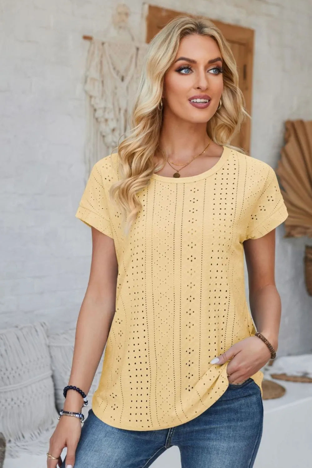 Light yellow eyelet round-neck T-shirt with short rolled sleeves