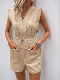 Tan sleeveless V-neck drawstring romper with button front and front pockets