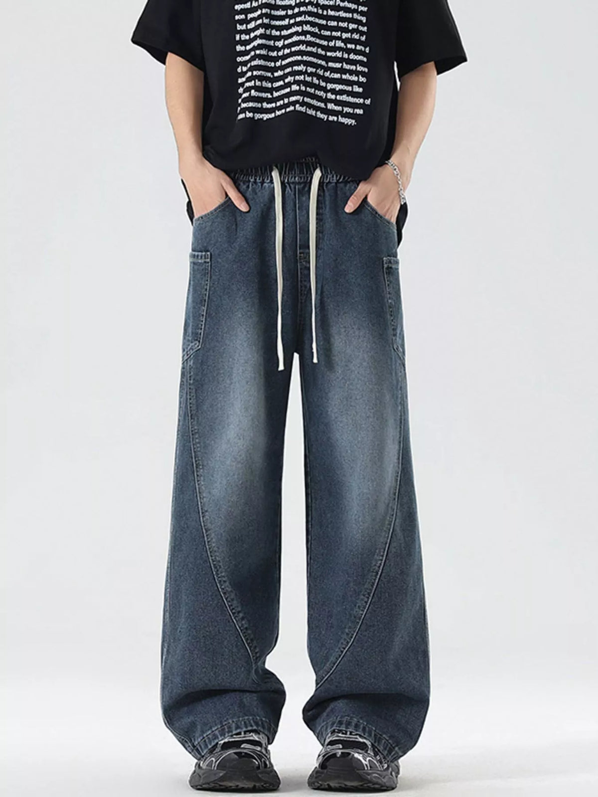Men's vintage wide-leg jeans in light blue denim with drawstring waist and roomy legs.
