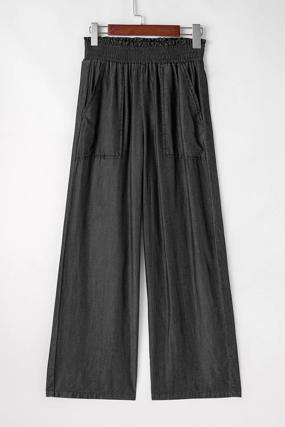 Black wide-leg pants with smocked waistband, gathered pleats, side pockets