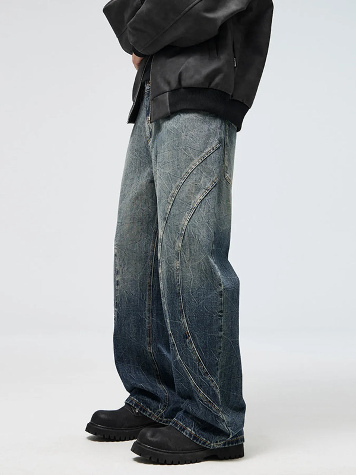 Men's wide-leg jeans with vintage blue wash and diagonal patch seams on the leg