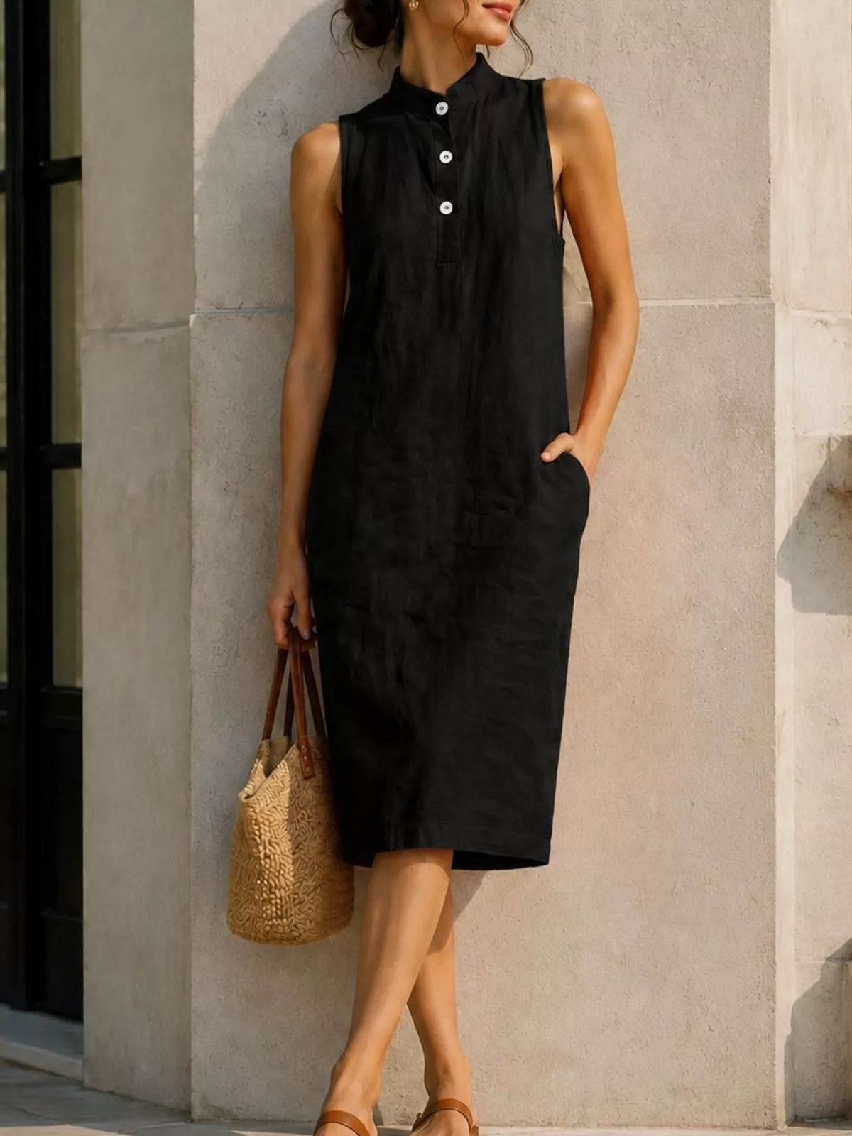 Black sleeveless midi dress with button placket and patch pockets