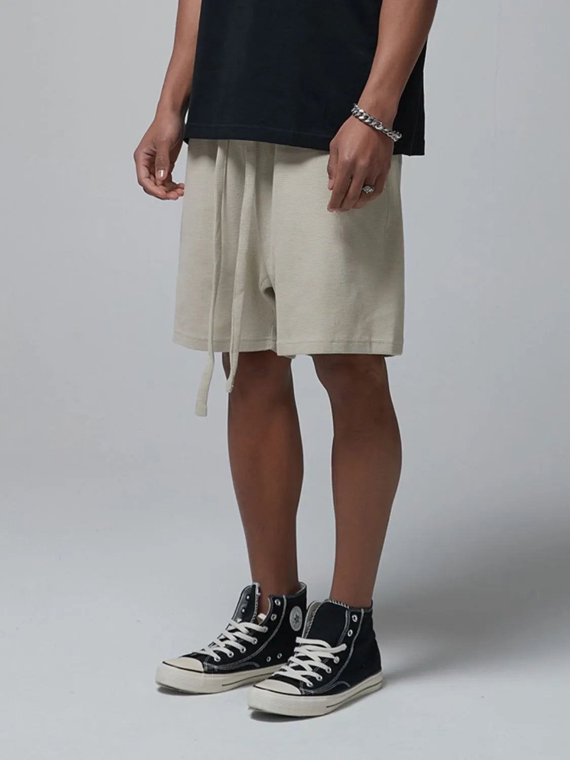 Men's beige waffle shorts with drawstring tie and side pockets, relaxed fit