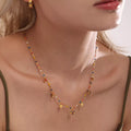 Gold-plated heart charm necklace with blue beads and small gold hearts