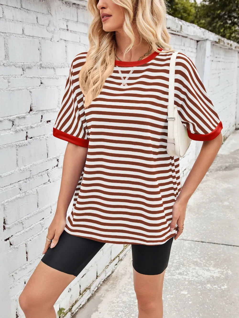 Striped round-neck half-sleeve T-shirt in white with brown stripes and red trim, side view
