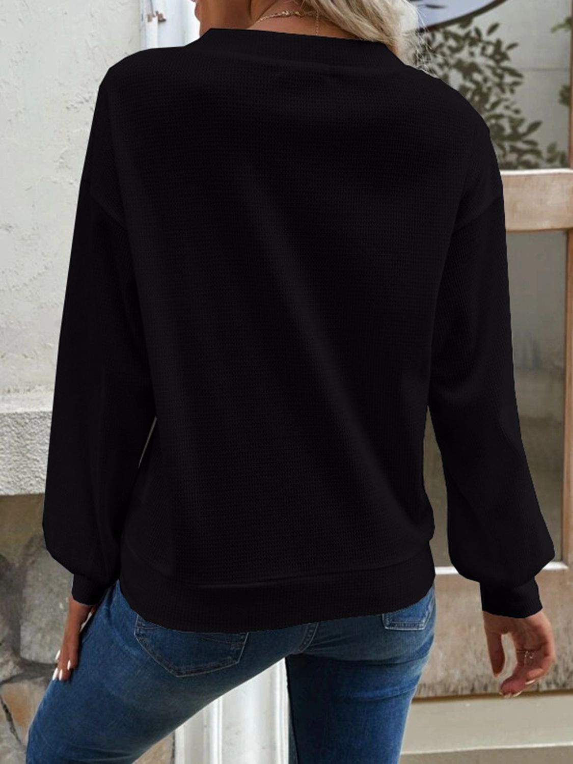 Black V-neck blouse back view with long sleeves and dropped-shoulder fit