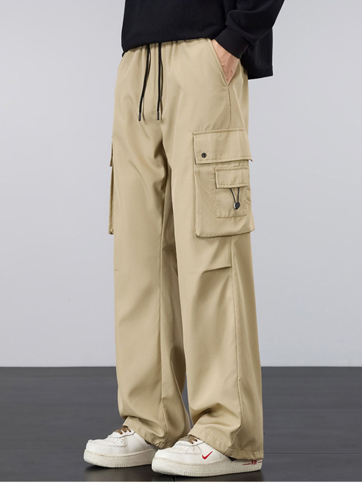 Khaki cargo pants with drawstring waist, loose fit, and side cargo pocket