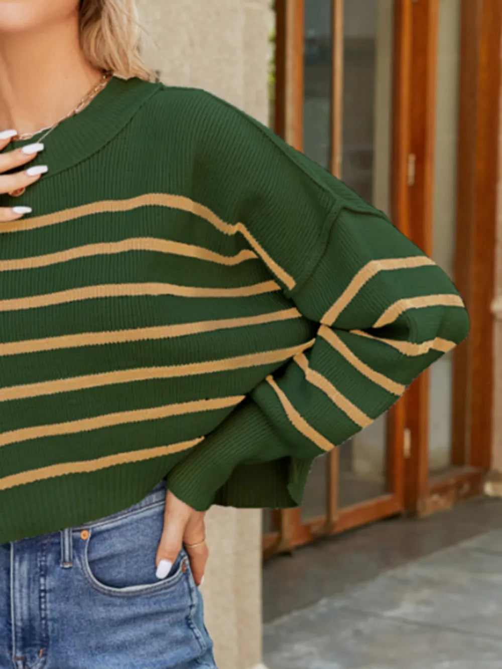 Green striped lantern sleeve sweater close-up with tan horizontal stripes and ribbed cuffs