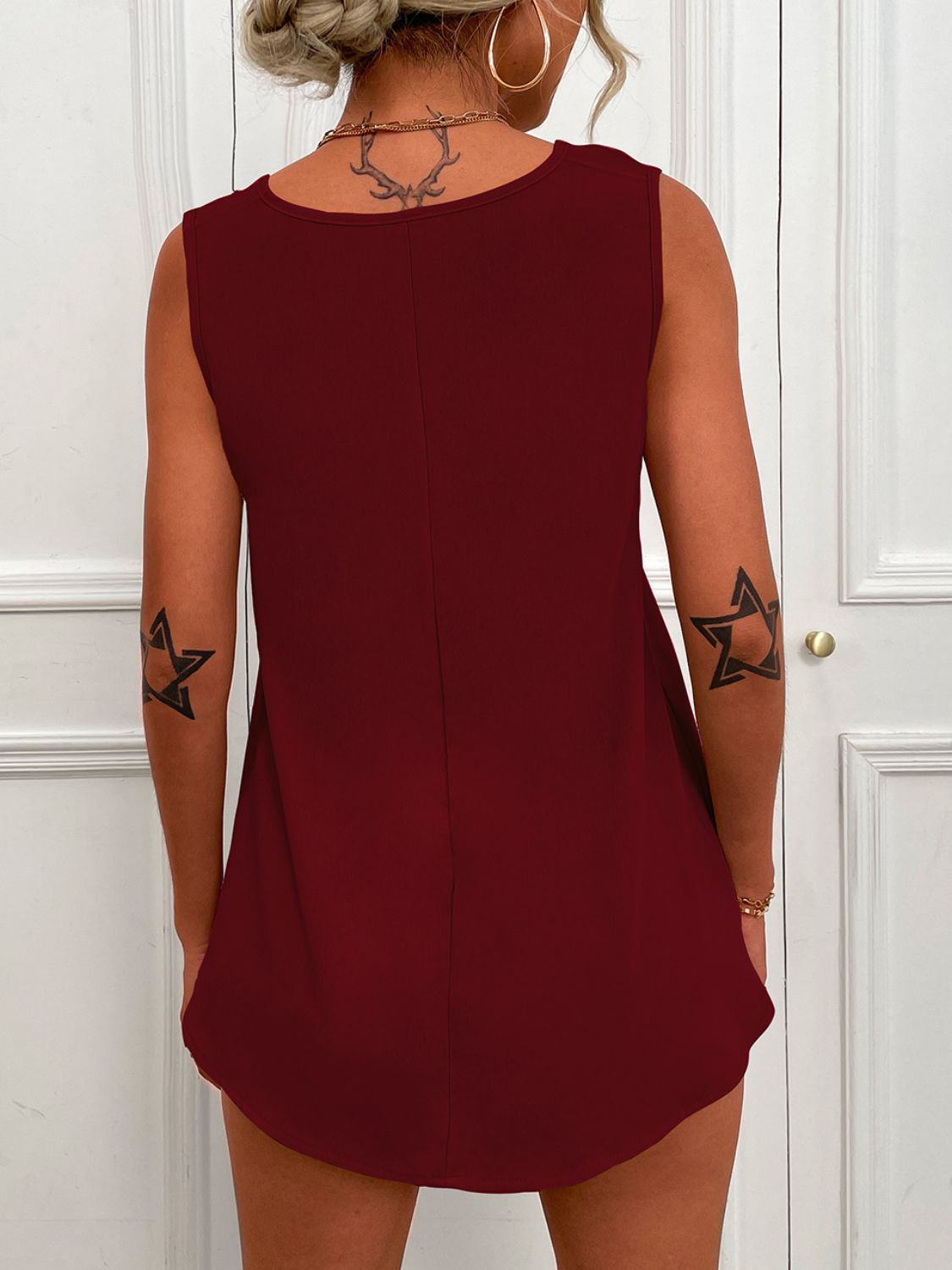 Burgundy sleeveless tunic tank with V-neck and curved back hem