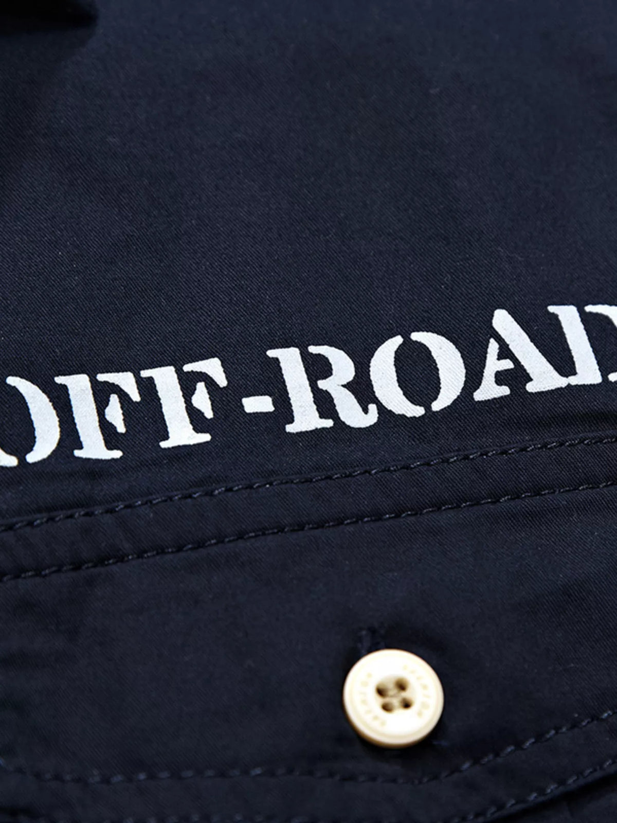 Dark navy shirt chest logo patch with white OFF-ROAD lettering and button placket