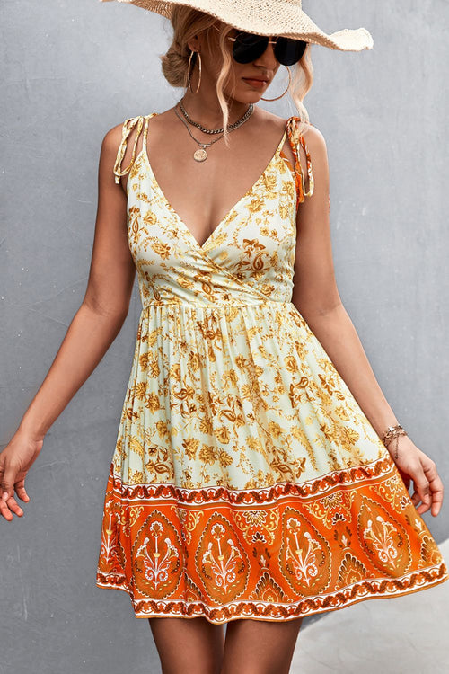 Light yellow tie-shoulder surplice dress with floral print and orange border hem
