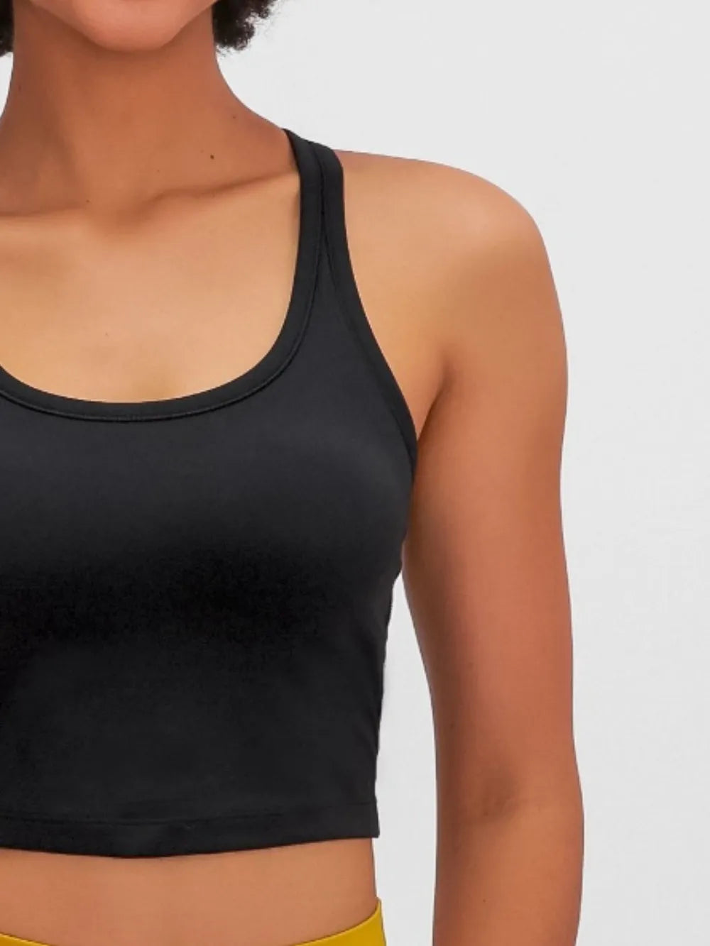 Black active scoop-neck tank with detachable chest pads, sleeveless cropped fit