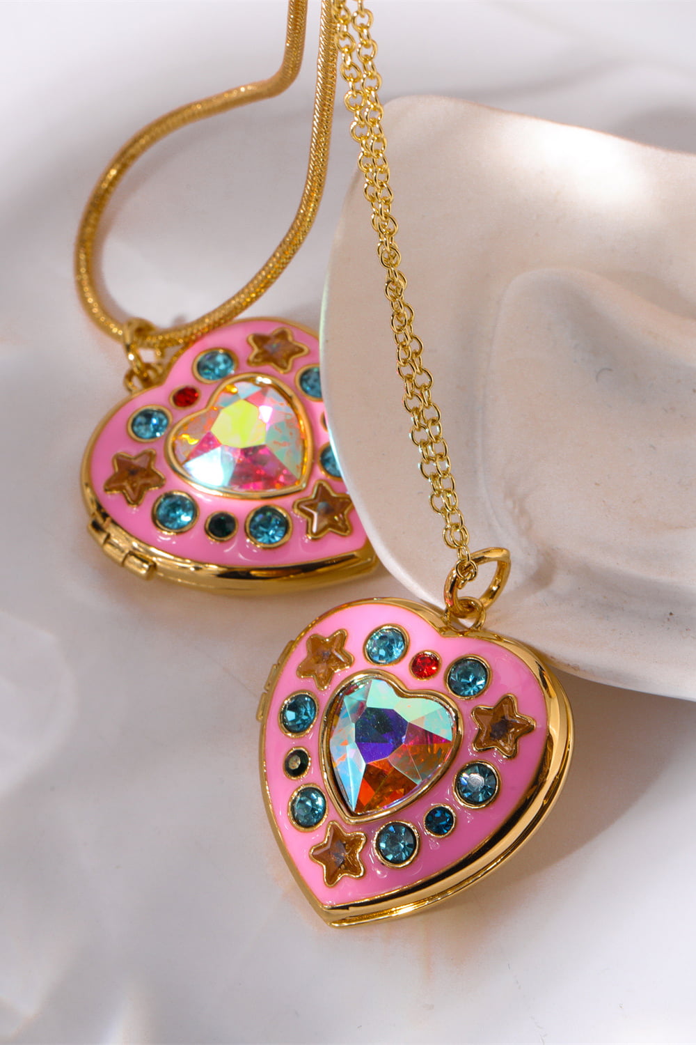 Gold-tone heart box pendant necklace with pink heart charms, rhinestones, and rainbow gem