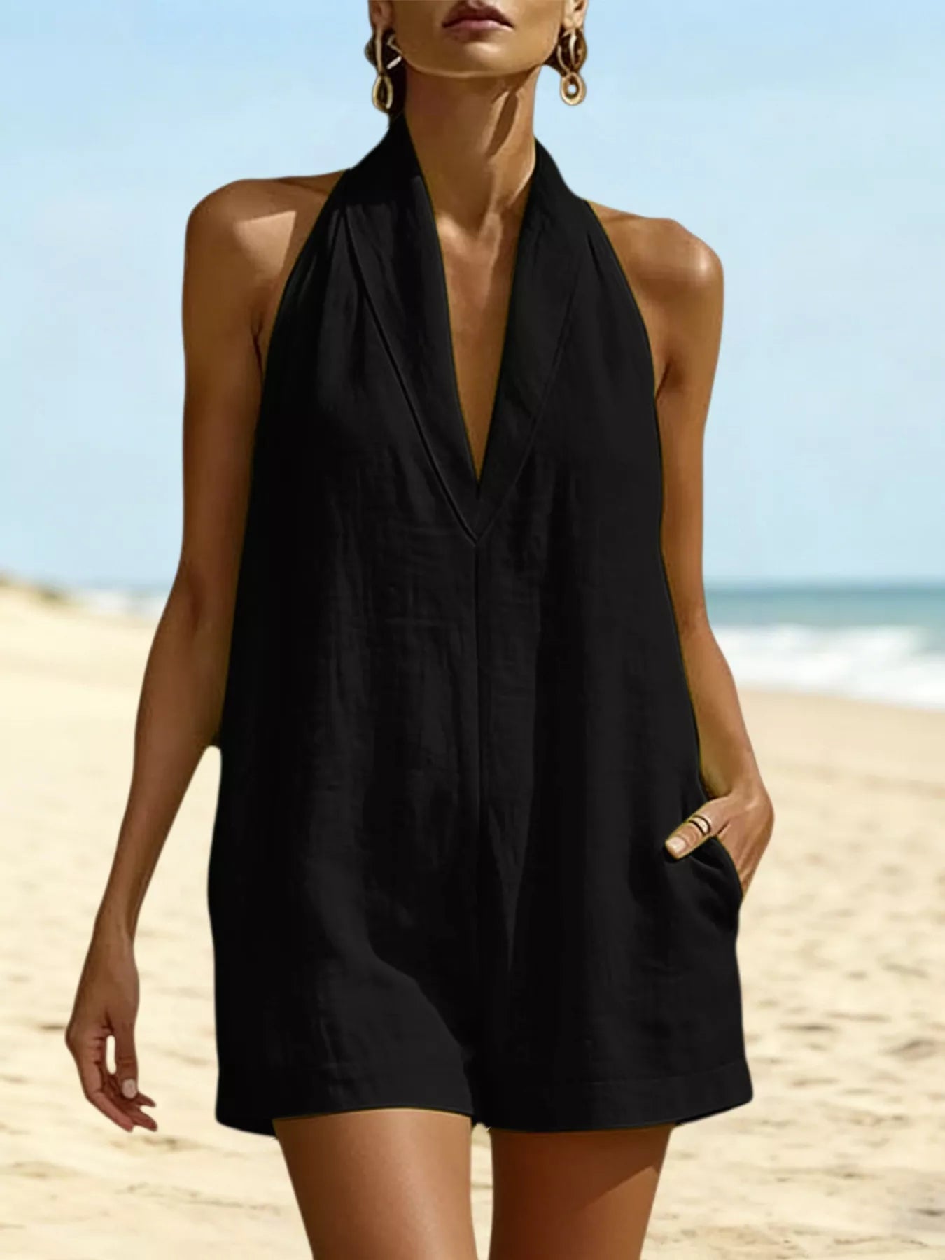 Black halter-neck romper with V neckline and front pockets, short legs