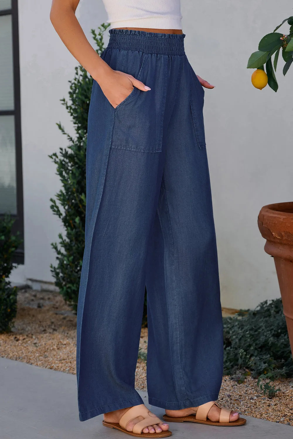 Peacock blue wide-leg denim pants with side pockets and elastic waistband.