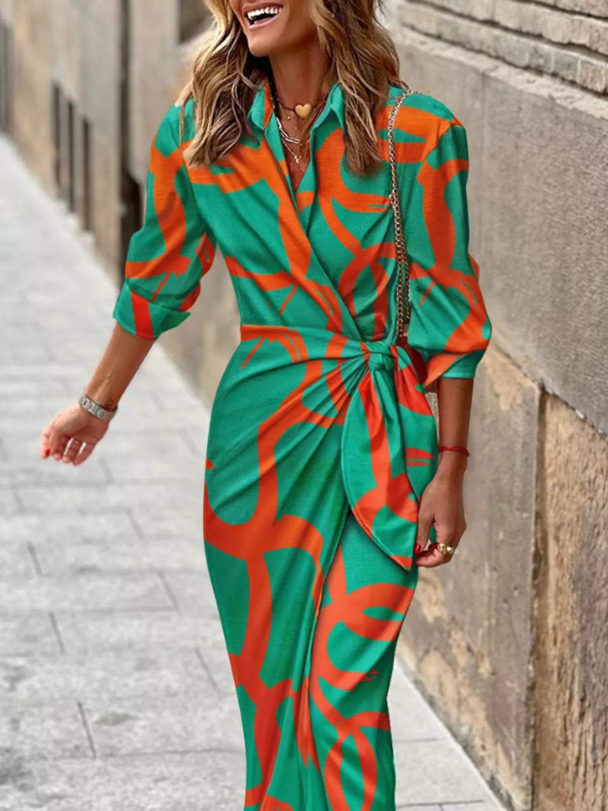 Teal wrap midi dress with orange abstract pattern, V-neck and tied waist belt