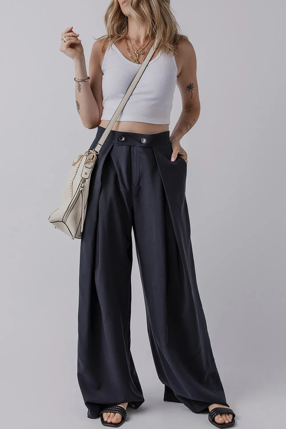 Dark navy wide-leg pants with pockets, pleated design and buttoned waistband.