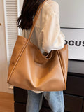 Khaki vegan leather tote bag with wide top handles and structured body