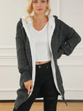 Open-front hooded winter coat with pockets, dark textured knit and white hood lining.