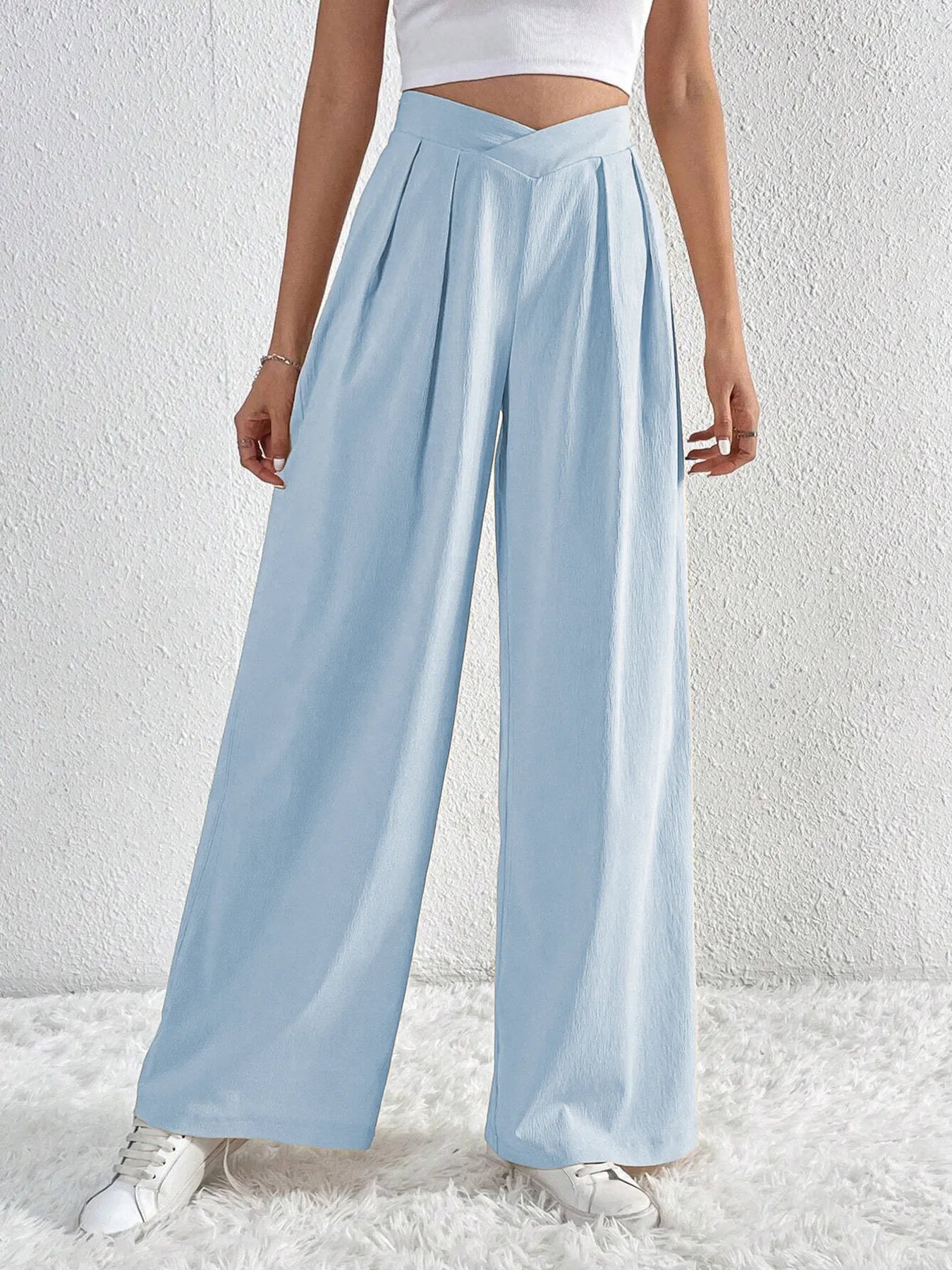 Light blue wide-leg pants with ruched V-waist and flowy wide-leg silhouette