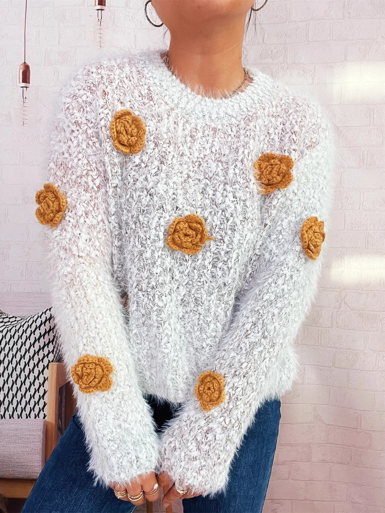 Flower-embellished round-neck sweater, fuzzy white knit with scattered orange rosettes