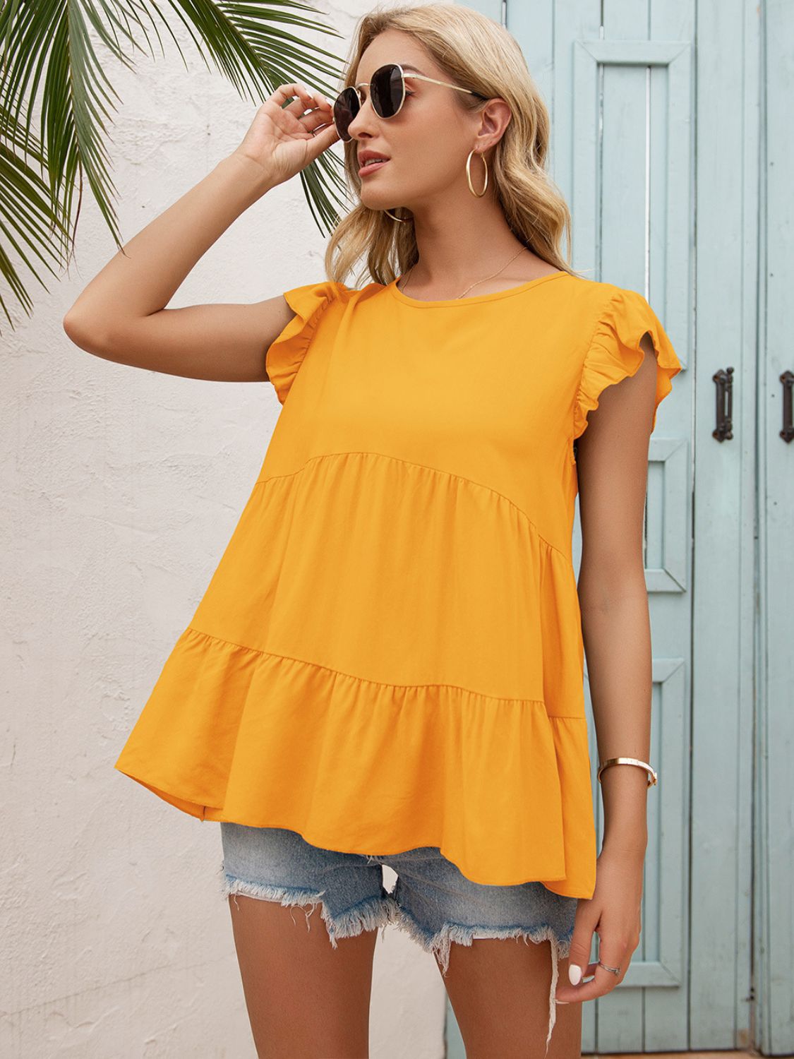 Orange round-neck tiered blouse with ruffle tiers and short flutter sleeves