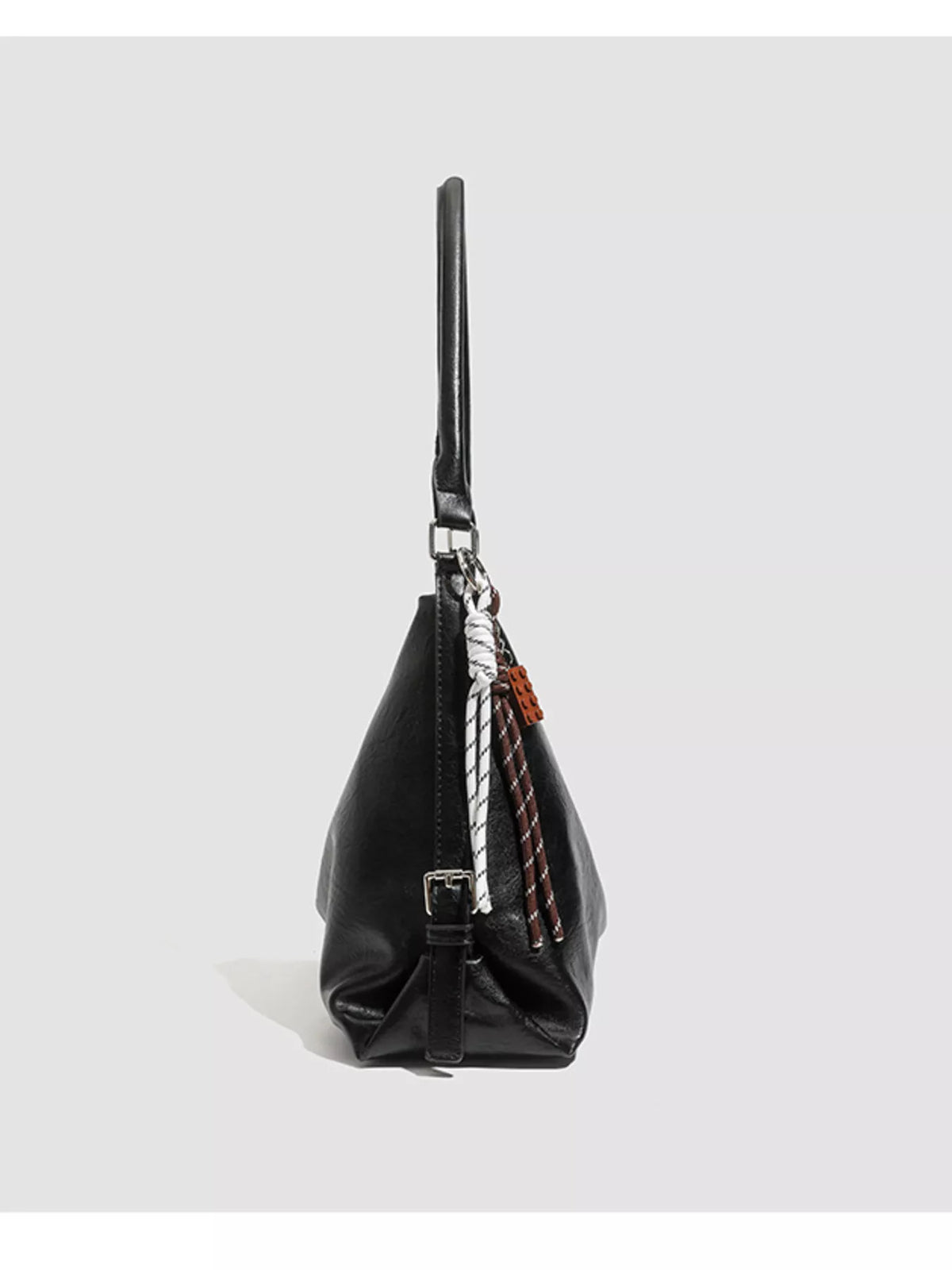 Black shoulder bag with long strap, side zip pocket, and braided detail