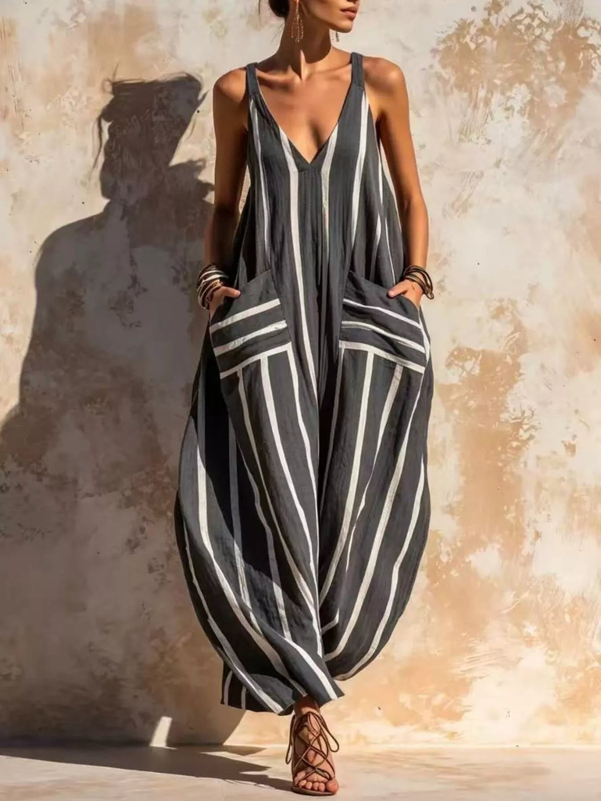Dark gray striped V-neck sleeveless wide-leg jumpsuit with draped side pockets
