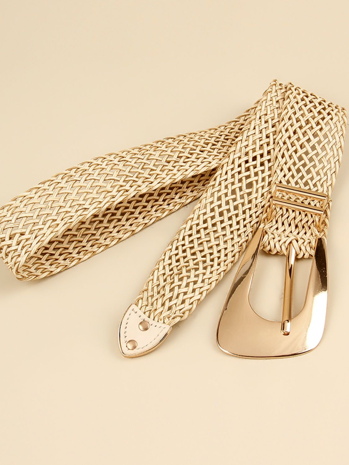Woven gold braided belt set with irregular buckle and two strap ends, close-up