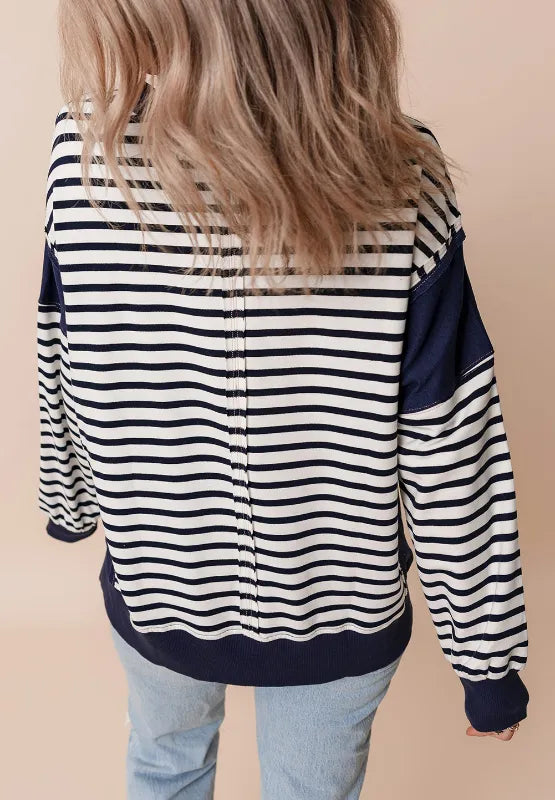 Back view of striped long sleeve sweatshirt with exposed seam, navy and white stripes
