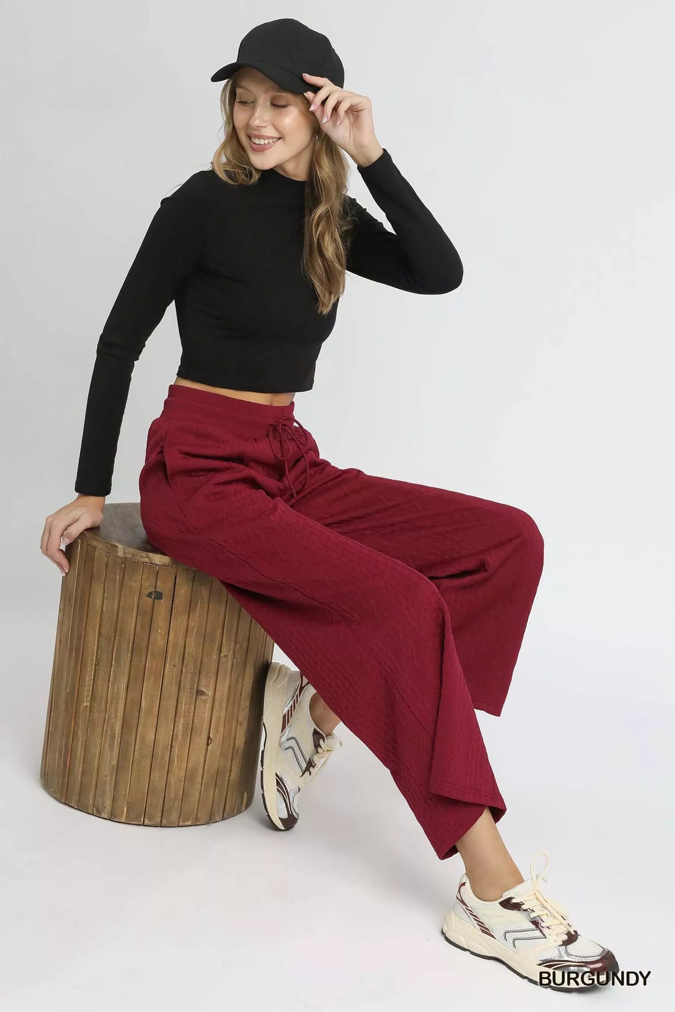 Burgundy wide-leg pants with drawstring waist and textured cable-knit look