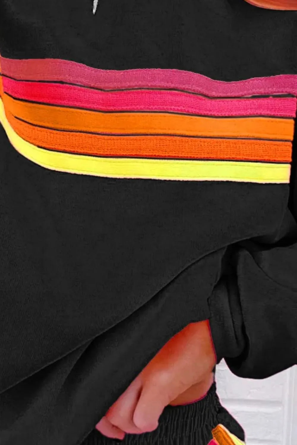 Black top and shorts set with colorful horizontal striped band across chest