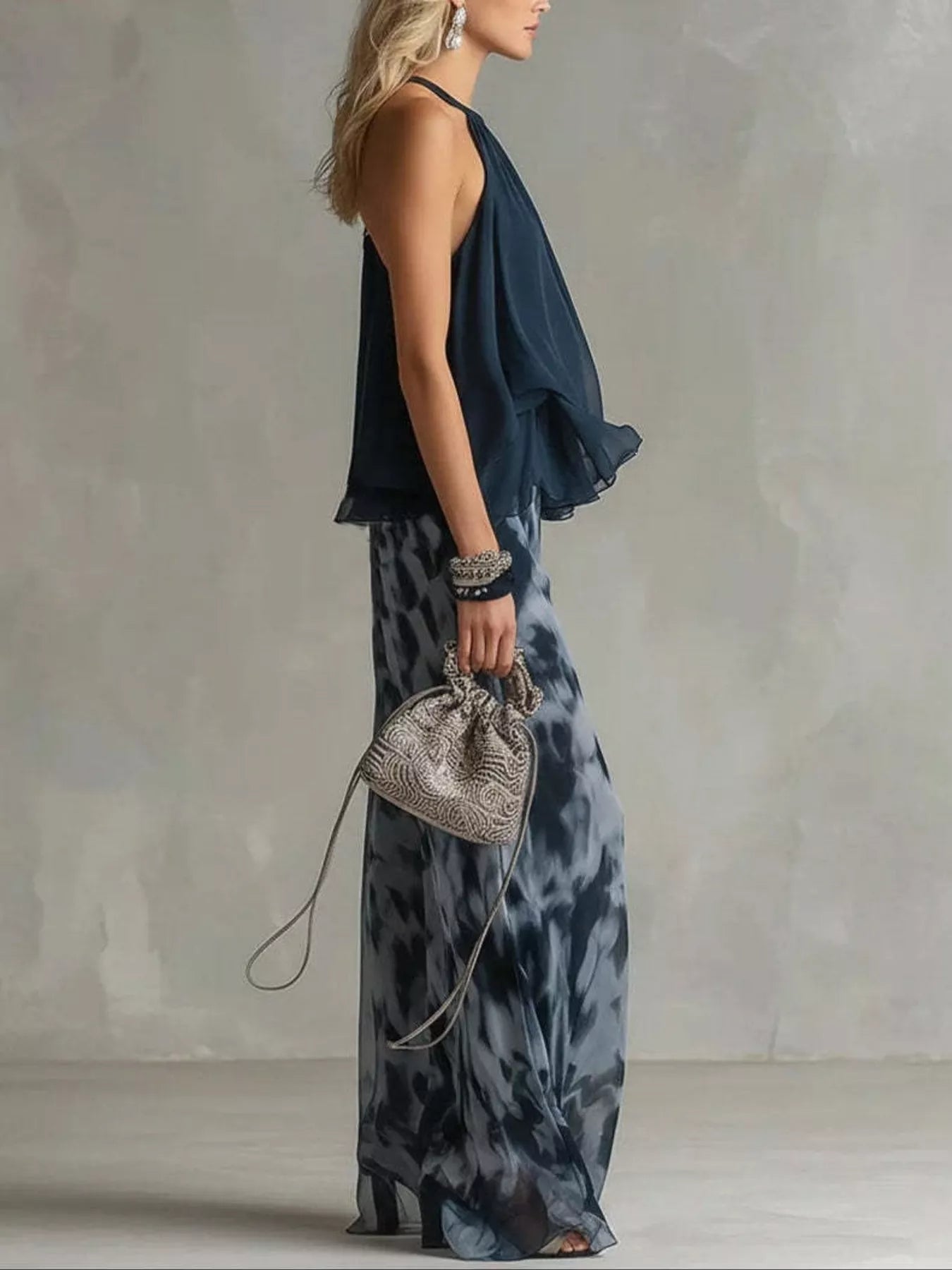 Dark blue halter ruffle top with tie-dye wide-leg pants, side drape view.