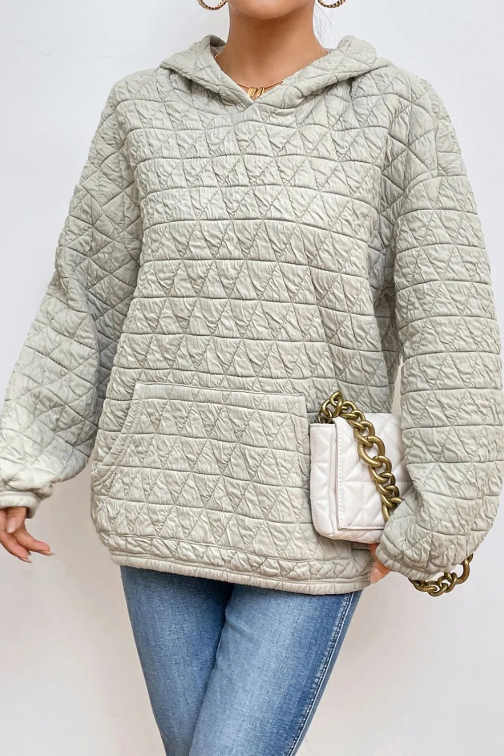 Light gray quilted long-sleeve hoodie with hood and front pocket