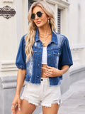 Distressed dark blue denim jacket, raw hem, button front, chest pockets.