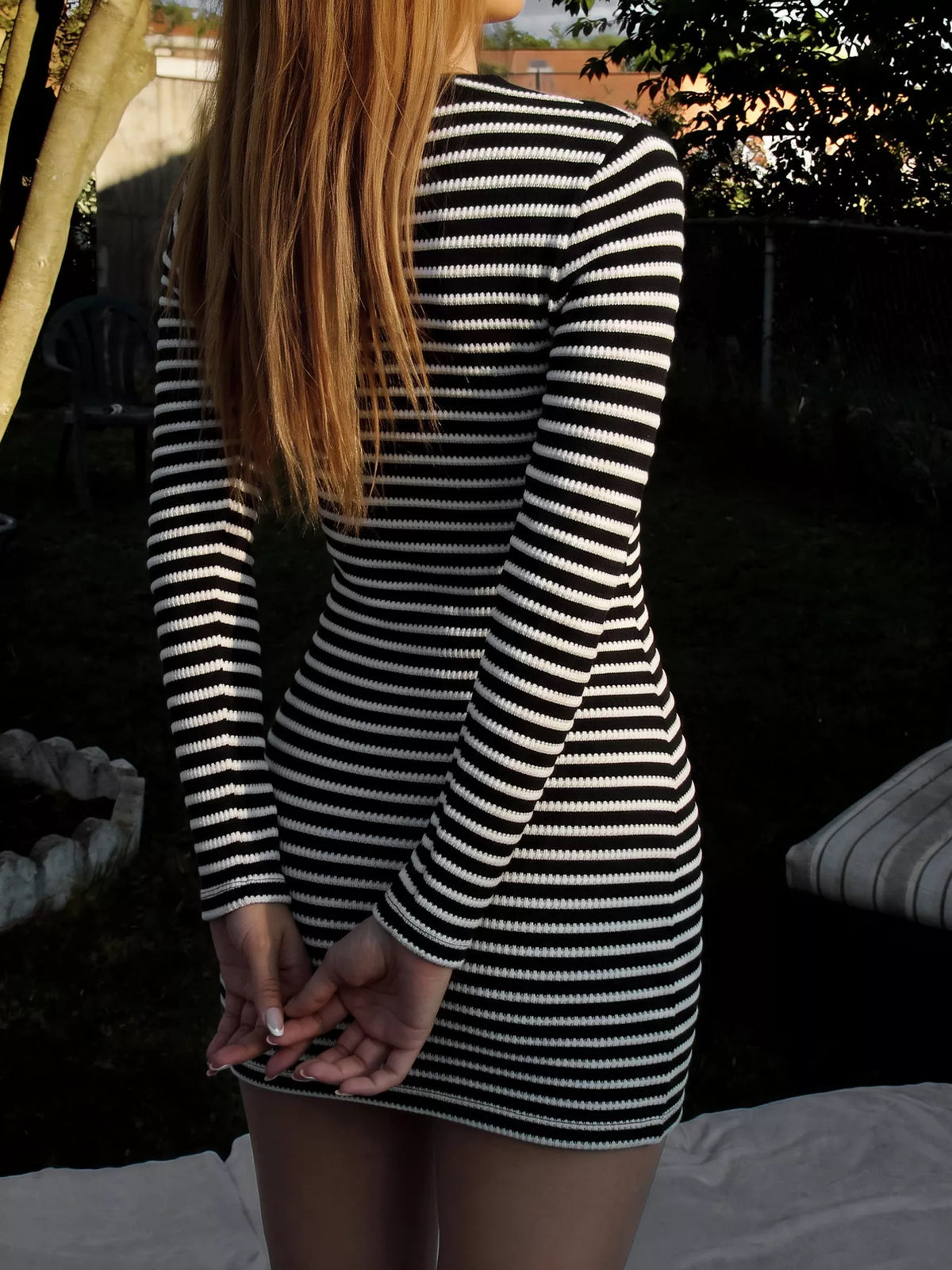 Black and white striped ribbed mini dress, fitted back view, long sleeves
