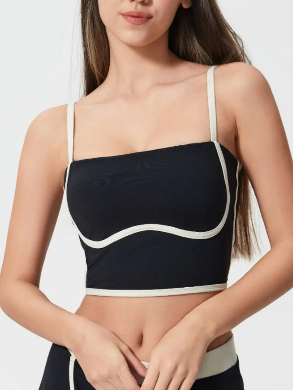 Black active cami with square neckline, contrast white trim, and molded chest pads
