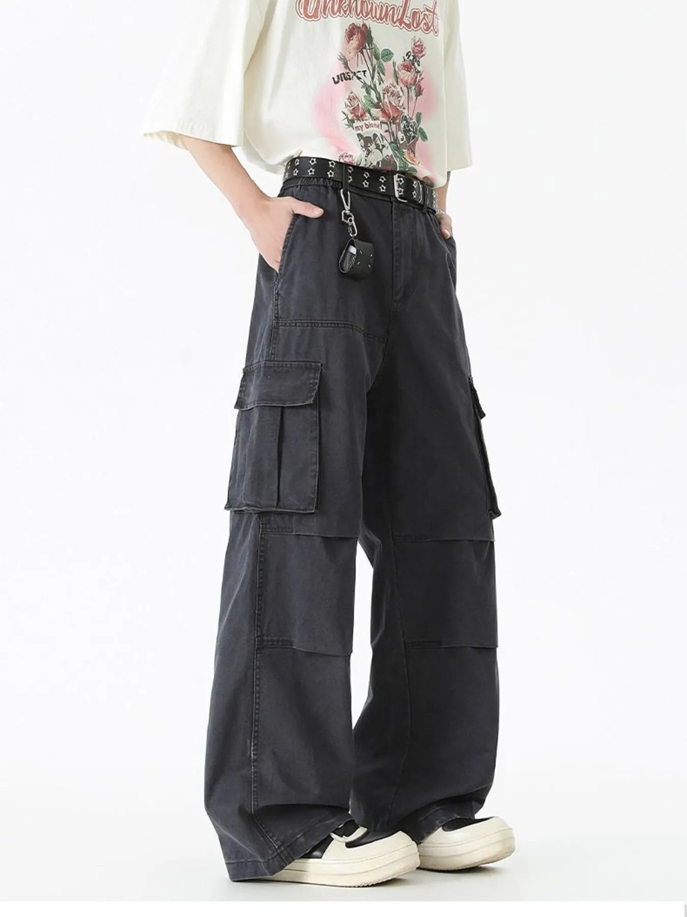 Black wide-leg cargo pants with side flap cargo pockets and studded belt