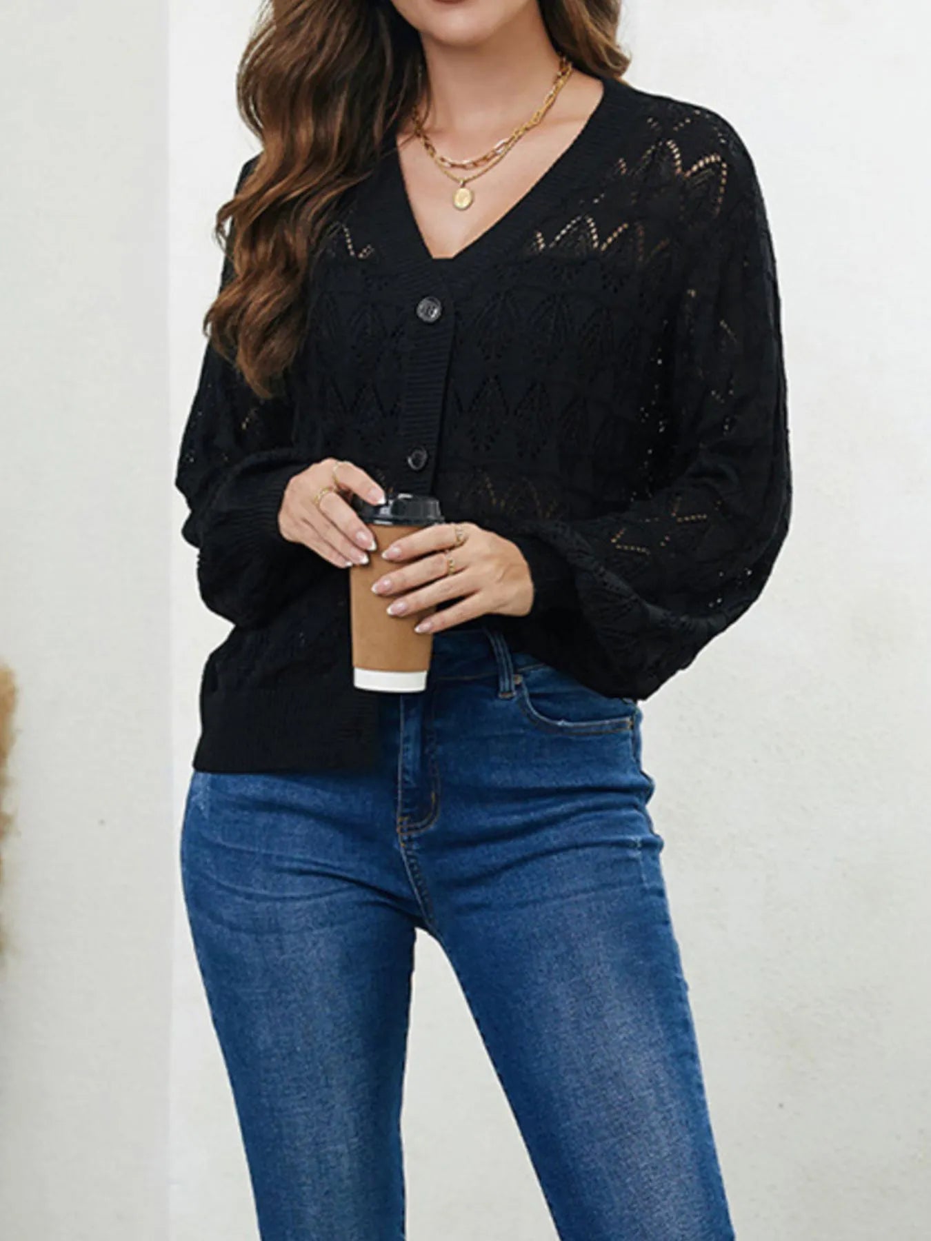 Black openwork button-up cardigan sweater with V-neck and long sleeves