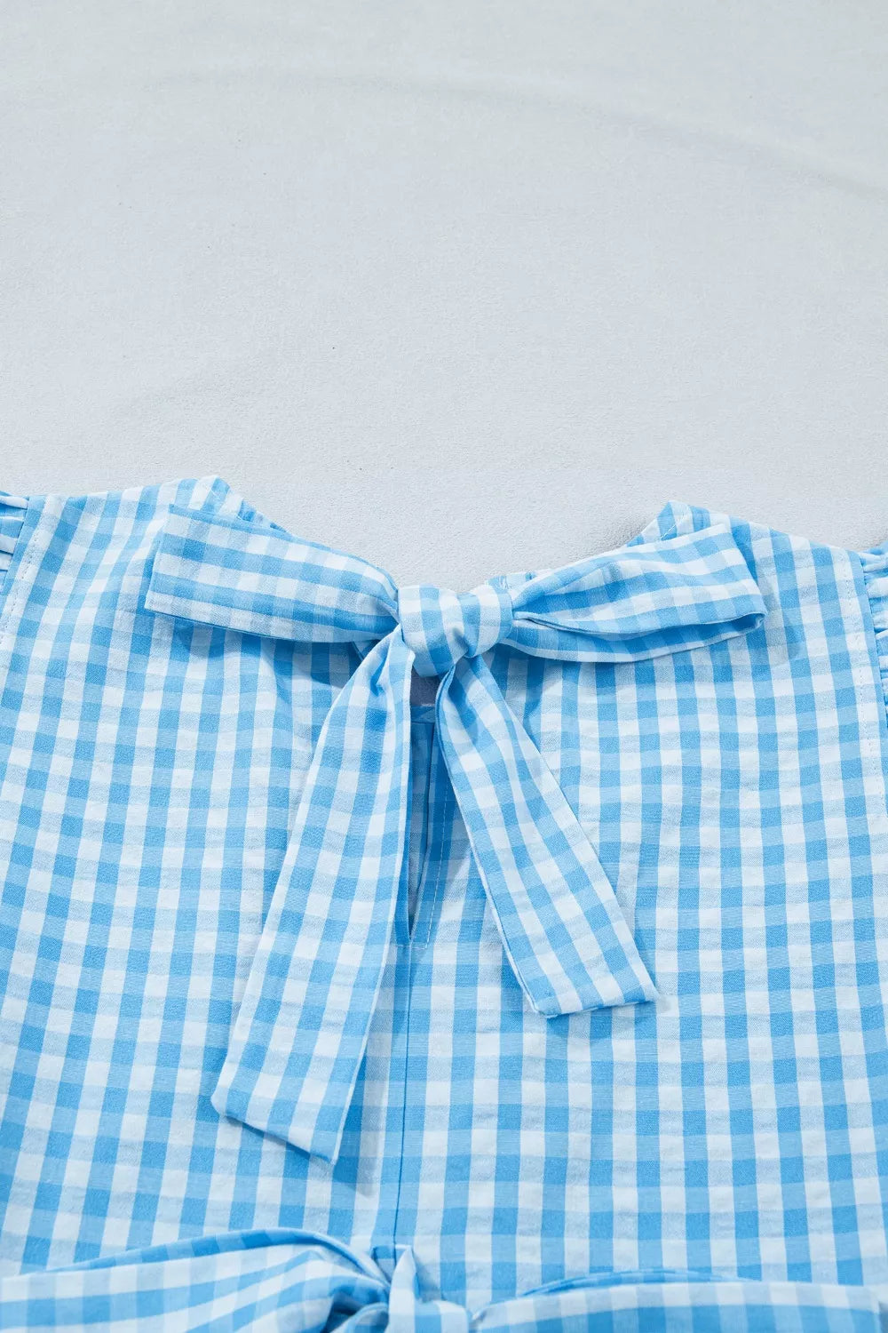 Cedar & Moore Knot Back Ruffled Short Sleeve Gingham Maxi Dress with blue gingham fabric and back bow.
