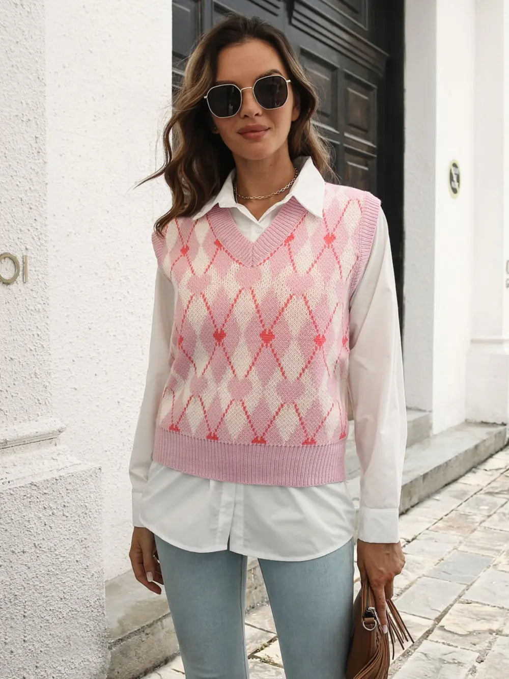 Blush pink geometric V-neck sweater vest with ribbed hem and diamond argyle knit