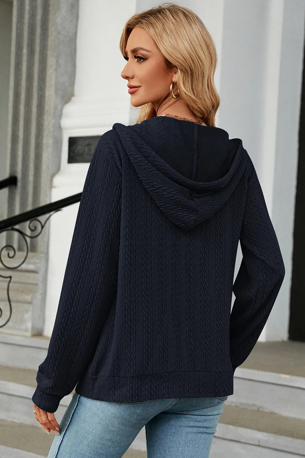 Dark blue drawstring zip-up hoodie, hooded back view with ribbed cuffs and hem