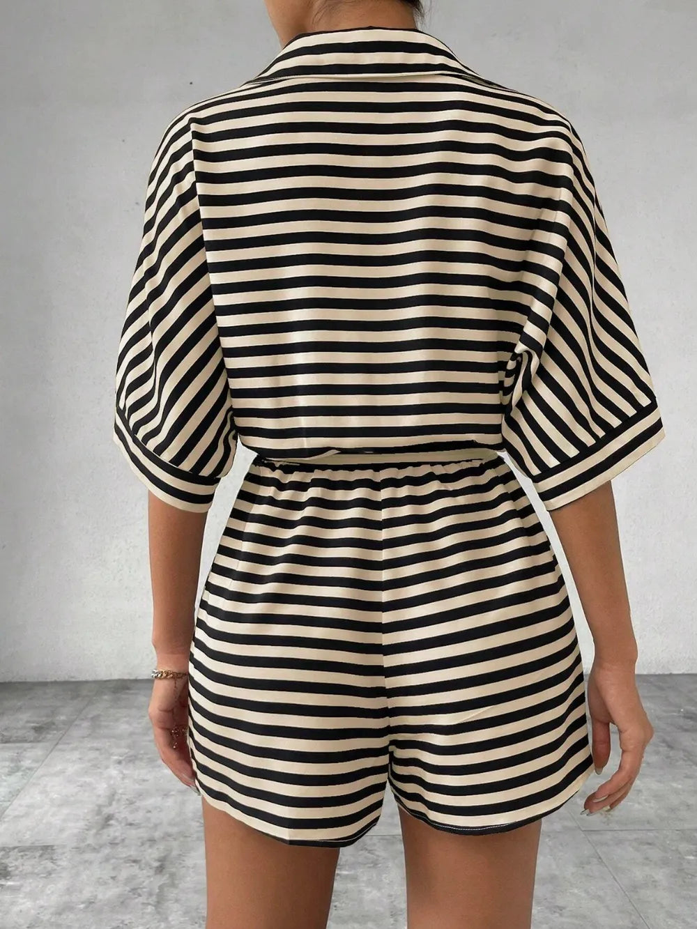 Striped tie-waist romper, back view with elastic waist and short sleeves, black/white stripes