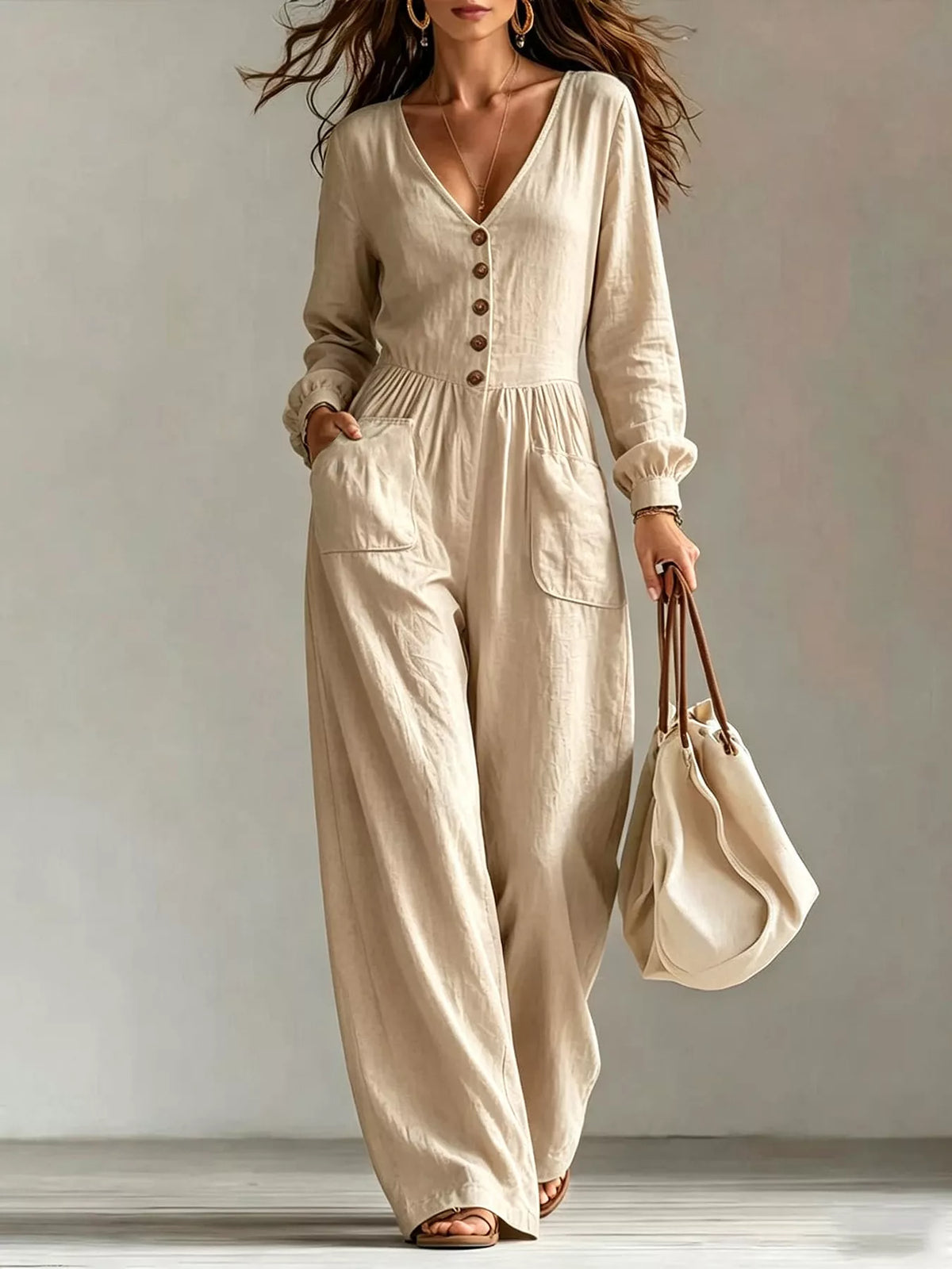 Ivory v-neck button-front wide-leg jumpsuit with long sleeves and side pockets