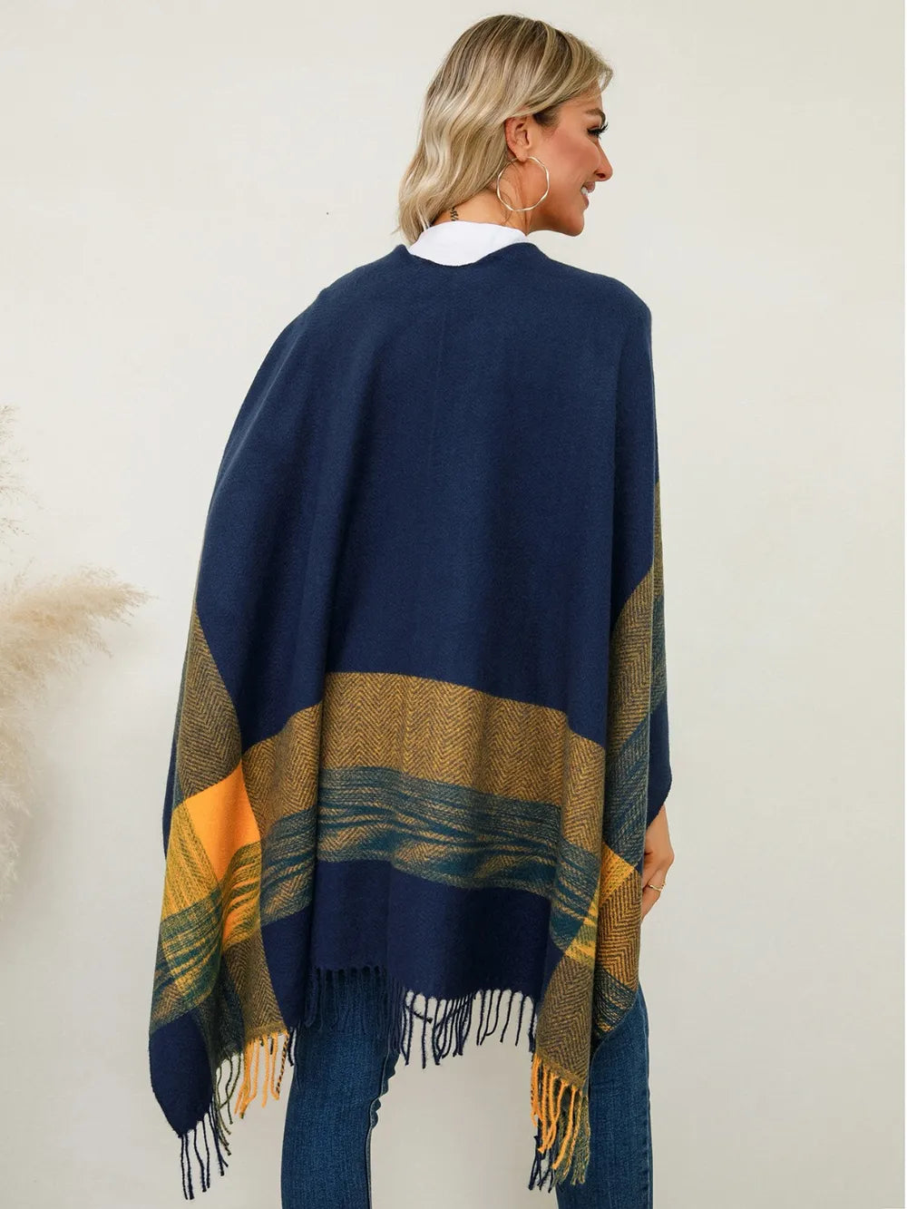 Fringe plaid poncho with navy back panel, olive and gold stripe bands, and fringe hem